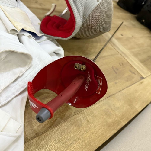 Fencing accessories used, helmet, sword, vest and bag
