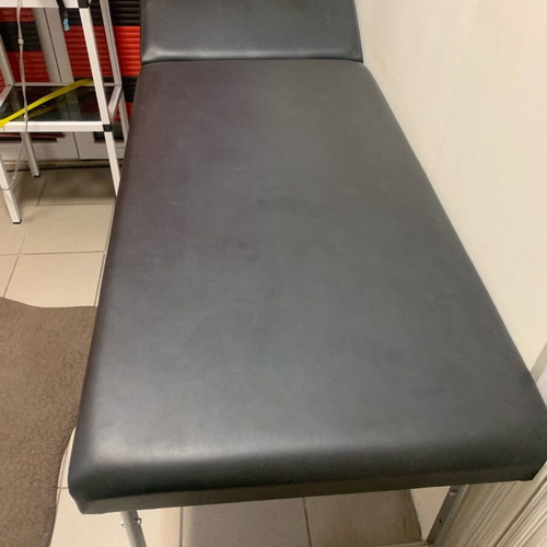 Examination bed used, black with inox folding legs