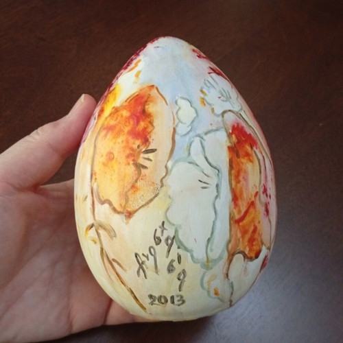 Hand-painted ceramic egg with floral and female figure design