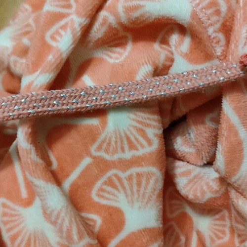 Pink cardigan used with white patterns and zipper, size L