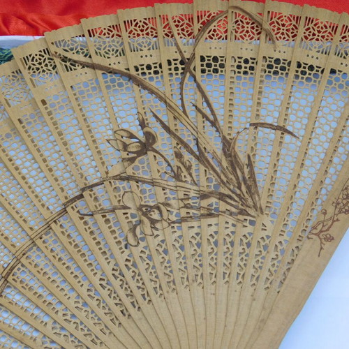Traditional Chinese sandalwood fan with decorative tassel