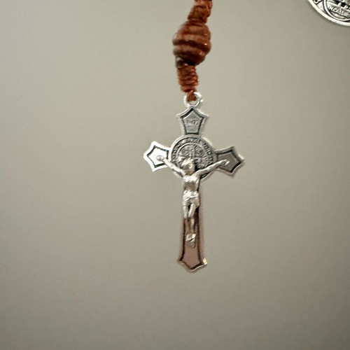 Religious bracelet with wooden beads, cross pendant, and Saint Benedict medal