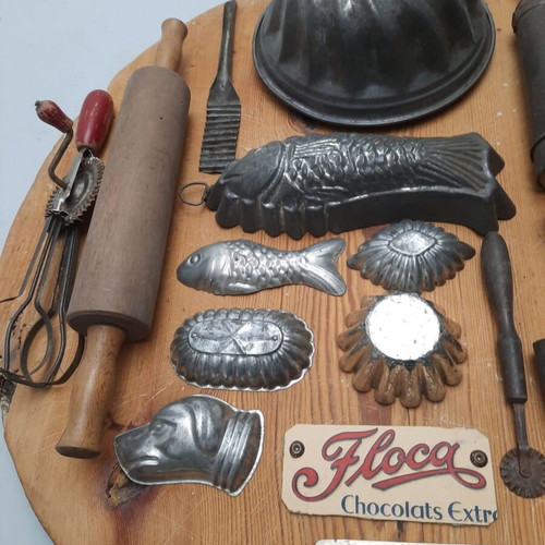 Collection of vintage pastry tools on wooden board