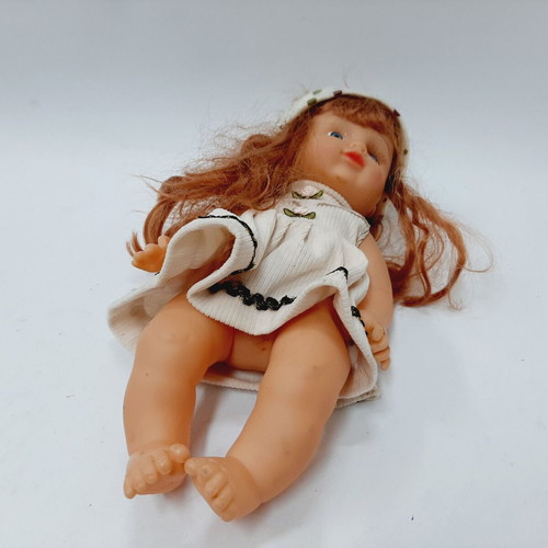 Vintage plastic doll 60s with open eyes, white knitted dress, tiara
