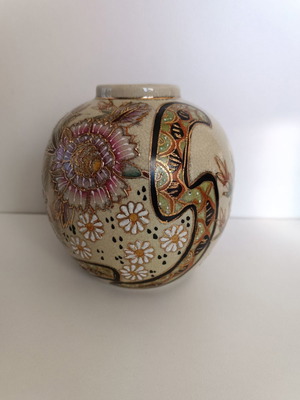 Small spherical decorative vase used with designs