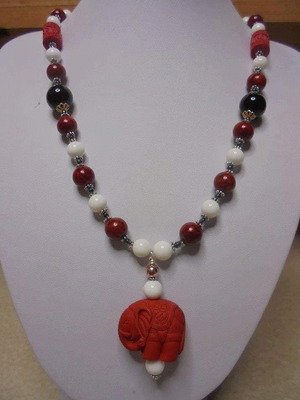 Necklace with black and white onyx, cinnabar elephant and coral new