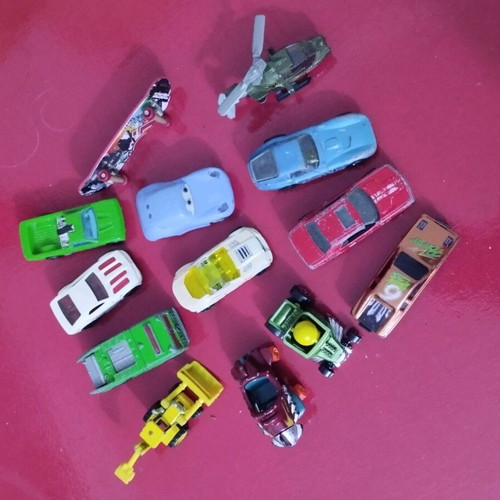 Set of various toy cars used, including helicopters and bulldozer
