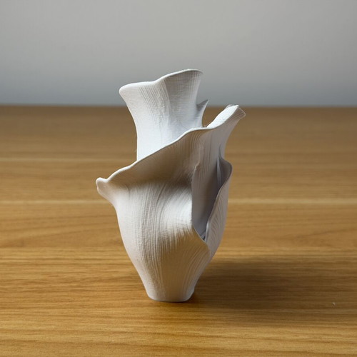 Decorative vase sculpture with ethereal flower design