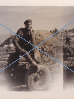 Black and white photo used, firing range with soldier and wheeled military equipment