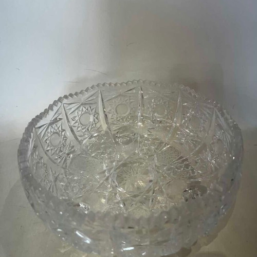 Vintage crystal bowl with feet and embossed carved designs, used