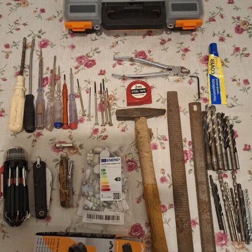Tool set used, including screwdrivers, pliers, hammer, drills, multitools