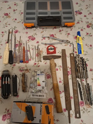 Tool set used, including screwdrivers, pliers, hammer, drills, multitools