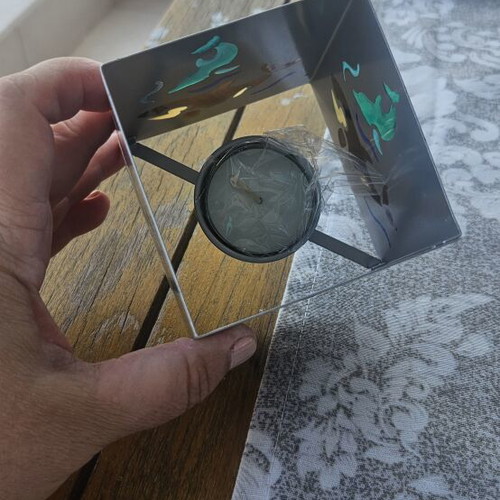 Metal tealight holder with stained glass dolphins