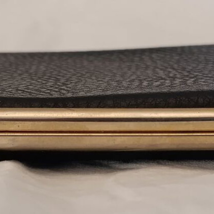Classic cigarette case used, black leatherette with bronze interior