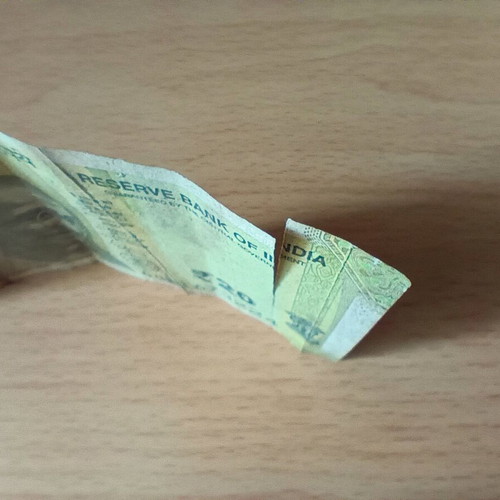 Indian 20 Rupees banknote used with tear