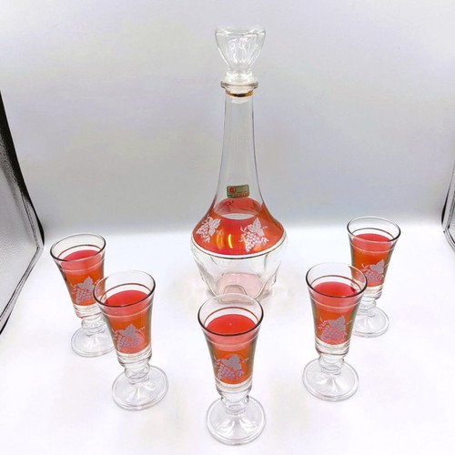 Italian glass decanter with glasses used, red with gold details