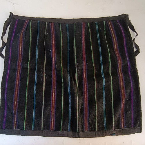Traditional apron with colorful vertical stripes, used