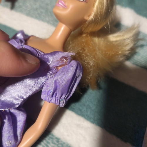 Barbie with lilac dress used, torn shoulders