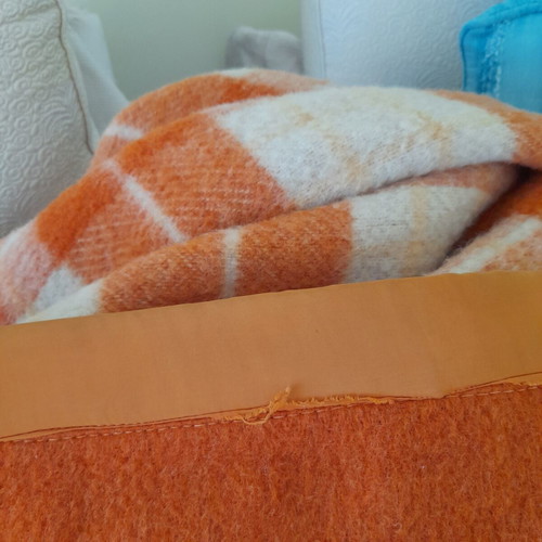 Wool blanket used, orange checkered bicolor