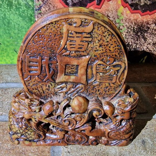 Stone carved sculpture used with dragons and coin
