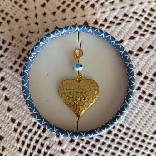Metal heart pendant with evil eye, like new, gold color