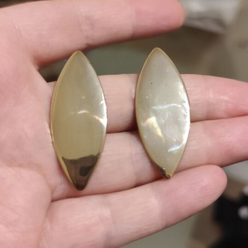 Leaf-shaped earrings used, gold color