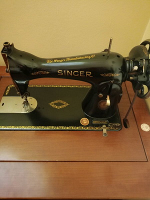 Singer treadle sewing machine used with wooden cabinet