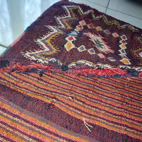 Old woven double horse saddle bag used with fabric tears