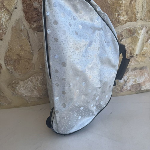 Smiley metallic travel bag used with embossed smiley and star designs