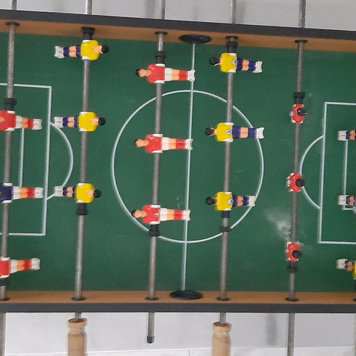 Wooden tabletop foosball used with wooden handles and 2 balls