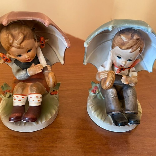 Ceramic figurines of two children with umbrella like new