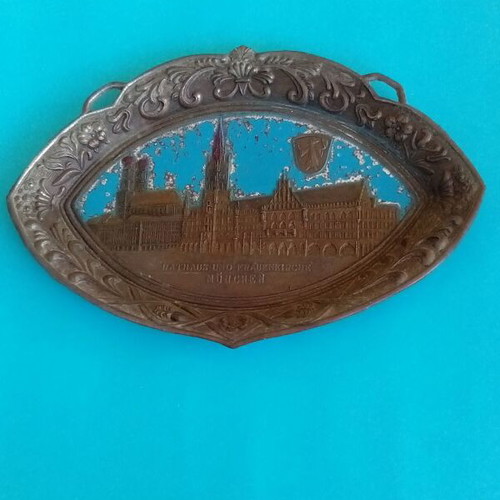 Metal wall plate used with embossed designs and old Munich town hall