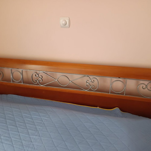 Double bed with decorated beech wood headboard