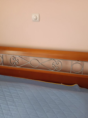Double bed with decorated beech wood headboard