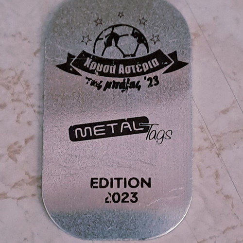 Two metal football cards