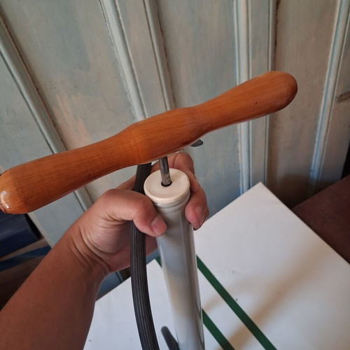 Manual air pump used with wooden handle and flexible hose