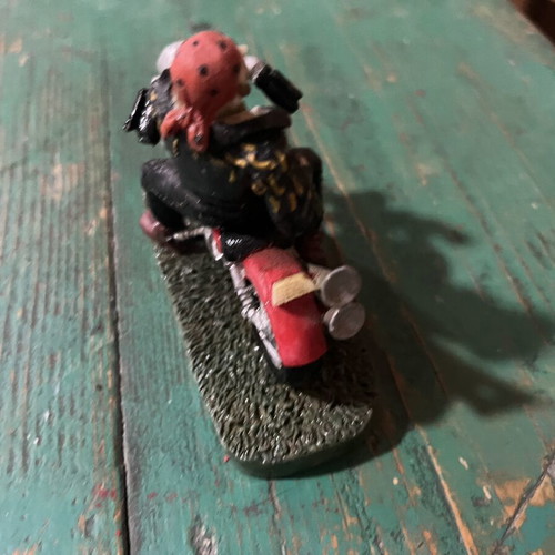 Vintage collectible biker figure on red motorcycle, like new