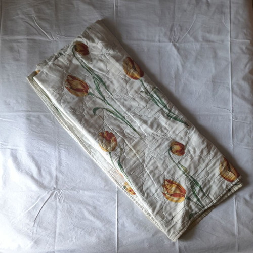 Single quilt used, white with floral patterns