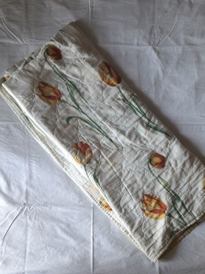 Single quilt used, white with floral patterns