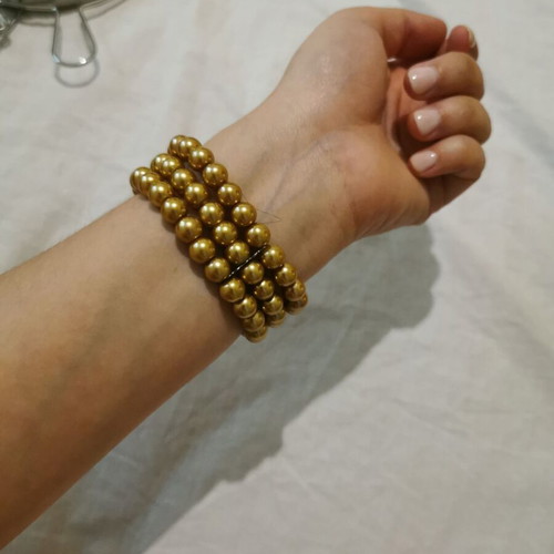 Bracelet with 3 rows of pearls in gold color like new
