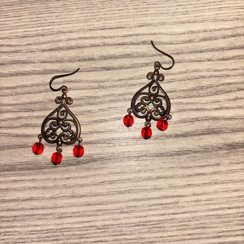 Earrings used with red plastic beads and bronze metal