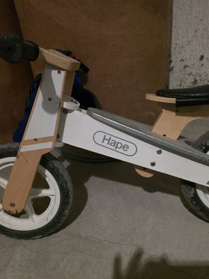 Hape wooden balance bike used with helmet