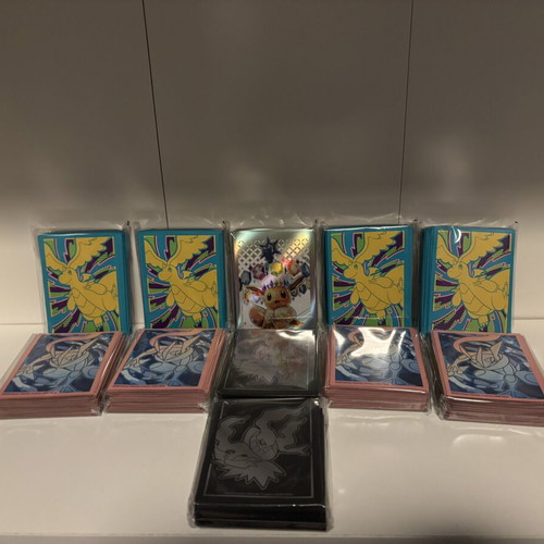 Pokemon card sleeves, 11 packs from different sets