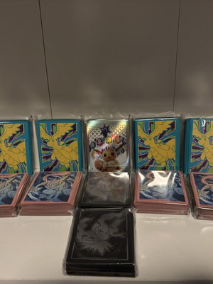Pokemon card sleeves, 11 packs from different sets