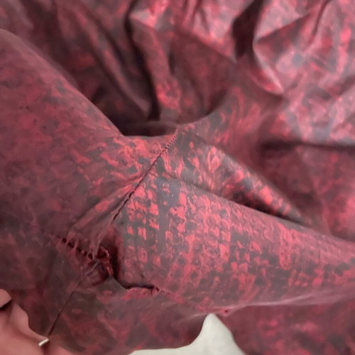 Nike snake print pants with signs of wear