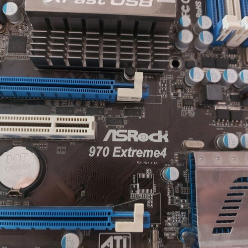 AsRock 970 Extreme4 AM3+ motherboard used, functional with updated BIOS