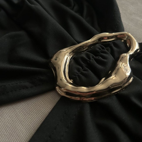 Black halter top with gold detail and open back