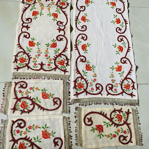 Set of embroidered handmade table linens used