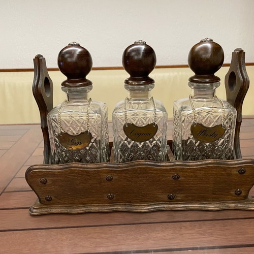 Vintage English decanters used in wooden stand for gin, cognac, whisky