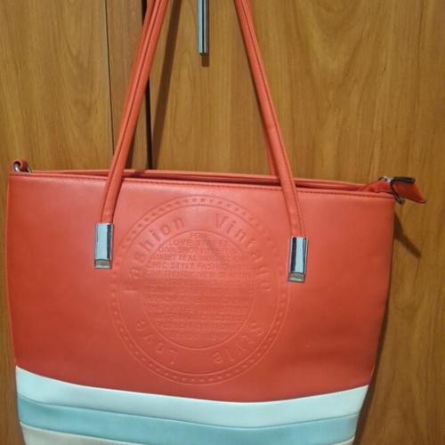 Red shoulder bag used with multiple compartments and zippers